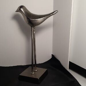 Elegant Silver Bird Sculpture A graceful addition to any decor. Solid yet sleek.